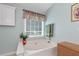 Bright bathroom featuring a soaking tub, neutral tones, and modern fixtures for a relaxing experience at 914 Wenham Ln, Lawrenceville, GA 30044