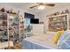 Cozy bedroom with ample shelving for decor, a ceiling fan, and a neutral color scheme at 914 Wenham Ln, Lawrenceville, GA 30044