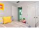 Bedroom with doorway to bathroom, bright yellow pillows, and neutral colored walls at 914 Wenham Ln, Lawrenceville, GA 30044