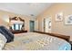 Spacious bedroom with a vaulted ceiling, soft color palette, and elegant furnishings for a serene atmosphere at 914 Wenham Ln, Lawrenceville, GA 30044