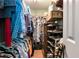 Organized walk-in closet with ample hanging space, shelving, and storage solutions for efficient organization at 914 Wenham Ln, Lawrenceville, GA 30044