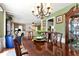 Charming dining room with elegant chandelier, a large wood table, and a classic china cabinet at 914 Wenham Ln, Lawrenceville, GA 30044