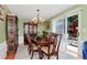 Elegant dining room with wooden table, chandelier, and sliding glass doors to the backyard patio at 914 Wenham Ln, Lawrenceville, GA 30044