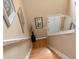 Inviting entryway with hardwood stairs, framed artwork, and a white front door, creating a warm welcome at 914 Wenham Ln, Lawrenceville, GA 30044