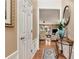 Inviting entryway featuring hardwood floors, decorative table, and a view into the comfortable living room at 914 Wenham Ln, Lawrenceville, GA 30044