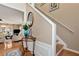 Entryway with hardwood floors, stairs, and decorative table with a view to the comfortable living room at 914 Wenham Ln, Lawrenceville, GA 30044