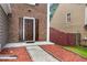 Inviting home exterior with brick accents, well-maintained lawn, and front door entry at 914 Wenham Ln, Lawrenceville, GA 30044