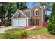 Exterior view of a two-story house with a two-car garage, showcasing the well-maintained lawn and brick accents at 914 Wenham Ln, Lawrenceville, GA 30044