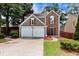 Charming two-story home featuring a two-car garage, manicured lawn, and a blend of siding and brick facade at 914 Wenham Ln, Lawrenceville, GA 30044
