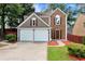 Charming two-story home with a two car garage, brick facade, and manicured landscaping at 914 Wenham Ln, Lawrenceville, GA 30044