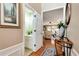 Hallway leading to a powder room, featuring hardwood floors, decorative molding, and stylish decor at 914 Wenham Ln, Lawrenceville, GA 30044
