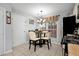 Cozy breakfast nook with a table and chairs next to a window and stainless-steel appliances at 914 Wenham Ln, Lawrenceville, GA 30044