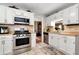 Modern kitchen with stainless steel appliances, white cabinets, and plenty of countertop space at 914 Wenham Ln, Lawrenceville, GA 30044
