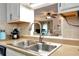 Stainless steel kitchen sink with a modern faucet, set into laminate countertops, with natural lighting at 914 Wenham Ln, Lawrenceville, GA 30044