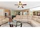 Inviting living room featuring a ceiling fan, comfortable seating, and a glass-top coffee table at 914 Wenham Ln, Lawrenceville, GA 30044