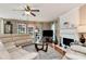 Spacious living room with hardwood floors, a fireplace, large windows, and comfortable leather furniture at 914 Wenham Ln, Lawrenceville, GA 30044