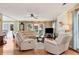 Comfortable living room featuring hardwood floors, neutral decor, a fireplace, and plenty of natural light at 914 Wenham Ln, Lawrenceville, GA 30044