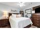 Well decorated primary bedroom with a king bed, ceiling fan, and neutral walls at 914 Wenham Ln, Lawrenceville, GA 30044