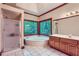 Bright bathroom featuring a garden tub under a large window, plus a shower at 110 Boulder Dr, Roswell, GA 30075