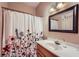 Bathroom featuring a sink, a floral shower curtain, and neutral paint at 110 Boulder Dr, Roswell, GA 30075