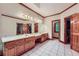 Bathroom showcasing a large vanity with double sinks and wood-look cabinets at 110 Boulder Dr, Roswell, GA 30075