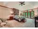 Spacious bedroom featuring a brick accent wall, neutral carpet, and access to a balcony at 110 Boulder Dr, Roswell, GA 30075