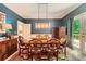 Formal dining room featuring a stylish light fixture, blue walls, and hardwood table ready for elegant gatherings at 110 Boulder Dr, Roswell, GA 30075