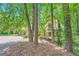 Charming yellow home nestled amongst lush green trees, offering a sense of seclusion and natural beauty at 110 Boulder Dr, Roswell, GA 30075