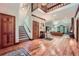 Spacious foyer boasts hardwood floors, stairs and an open view to the living room creating a welcoming ambiance at 110 Boulder Dr, Roswell, GA 30075