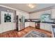 Well-lit kitchen with stainless steel refrigerator, white cabinets, and a stylish subway tile backsplash at 110 Boulder Dr, Roswell, GA 30075