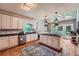 Bright kitchen features stainless steel appliances, center island, granite countertops, and hardwood floors at 110 Boulder Dr, Roswell, GA 30075