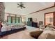 Spacious main bedroom featuring large windows, a vaulted ceiling, and comfortable seating area at 110 Boulder Dr, Roswell, GA 30075