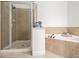Spa-like bathroom with separate shower and corner soaking tub at 1935 Cobblestone Ne Cir, Brookhaven, GA 30319