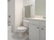 Bright white bathroom featuring tiled floors, white cabinets, and a shower-tub combo with tiled walls at 1935 Cobblestone Ne Cir, Brookhaven, GA 30319