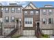 Brick townhouse exterior with multiple stories, a garage, and staircase up to the front door at 1935 Cobblestone Ne Cir, Brookhaven, GA 30319