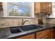 The kitchen features wooden cabinets, a granite countertop, and a stainless steel sink at 1935 Cobblestone Ne Cir, Brookhaven, GA 30319