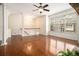 Spacious living room with hardwood floors, a ceiling fan and large bright window at 1935 Cobblestone Ne Cir, Brookhaven, GA 30319