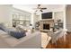 Bright living room features a stone fireplace, ceiling fan, and hardwood floors at 1935 Cobblestone Ne Cir, Brookhaven, GA 30319