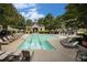 A refreshing community pool surrounded by mature trees and lounge chairs for relaxing in the sun at 1935 Cobblestone Ne Cir, Brookhaven, GA 30319
