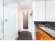 Modern bathroom with a clear glass shower, wood vanity with granite countertop, and contemporary fixtures at 199 14Th Ne St # 412, Atlanta, GA 30309