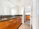 Bright bathroom featuring granite counters, modern wood cabinets, and stainless steel sink at 199 14Th Ne St # 412, Atlanta, GA 30309