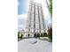 Elegant tall building with a beautiful circular driveway and mature landscaping in front of it at 199 14Th Ne St # 412, Atlanta, GA 30309