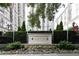 View of the Mayfair residence sign surrounded by beautiful plants and landscaping at 199 14Th Ne St # 412, Atlanta, GA 30309