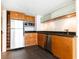 Modern kitchen with wood cabinets, stainless steel appliances, and black countertops, well lit at 199 14Th Ne St # 412, Atlanta, GA 30309
