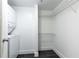 A clean laundry room features a stacked washer/dryer and wire shelving at 199 14Th Ne St # 412, Atlanta, GA 30309
