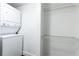 A laundry room features a stacked washer/dryer and wire shelving at 199 14Th Ne St # 412, Atlanta, GA 30309