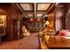 Elegant library featuring rich wood paneling, coffered ceilings, and extensive shelving filled with books, and comfortable seating at 199 14Th Ne St # 412, Atlanta, GA 30309