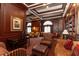 Cozy library showcasing detailed wood paneling, a coffered ceiling and ample seating options at 199 14Th Ne St # 412, Atlanta, GA 30309