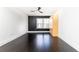 Open living room area with hardwood floors, a ceiling fan, and a large window for natural light at 199 14Th Ne St # 412, Atlanta, GA 30309
