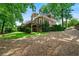 Manicured backyard with brick home and lush landscaping at 2202 Lattimore Farm Nw Dr, Kennesaw, GA 30152